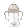 Clear sippy cup with beige lid and handles on a white background, featuring the b.box logo.
