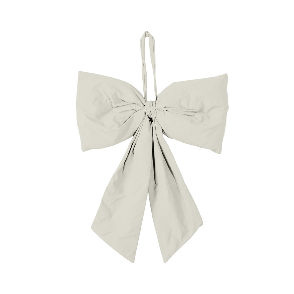 Beige bow-shaped top on a white background