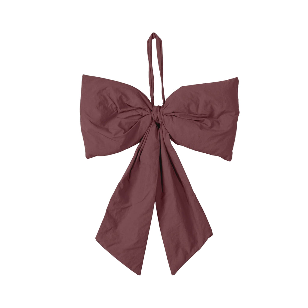 Maroon bow-shaped top on a light gray background