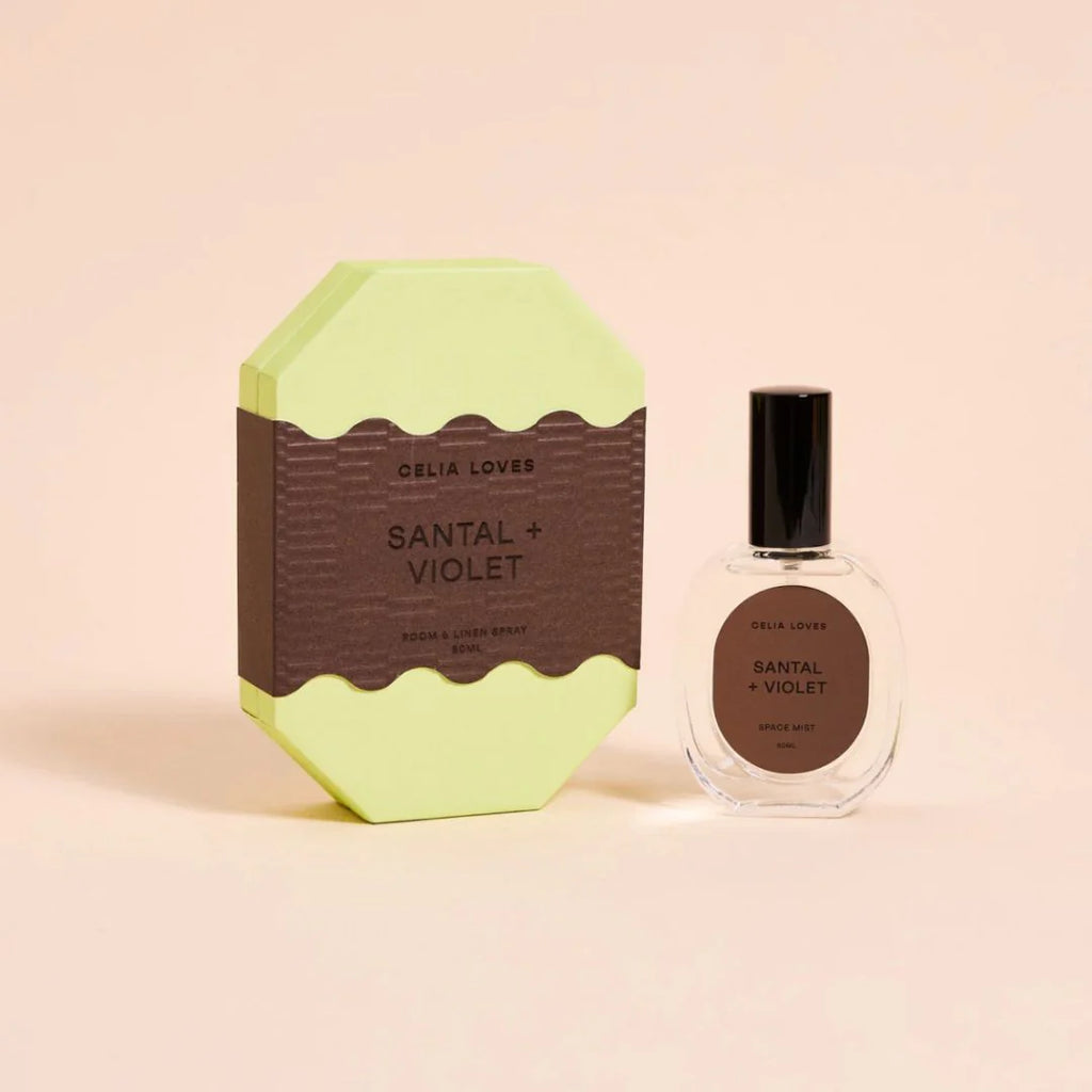 Perfume bottle and packaging with 'Celia Loves' branding on a beige background