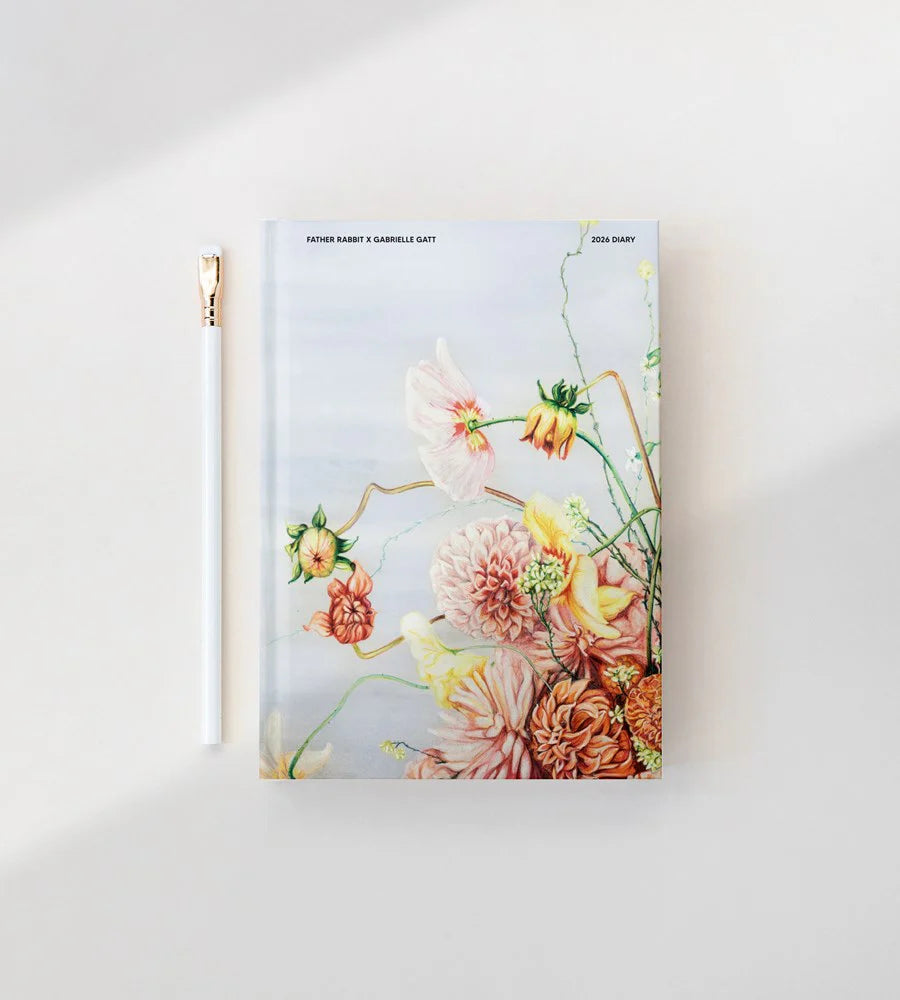 Floral notebook with a gold zipper on a white background