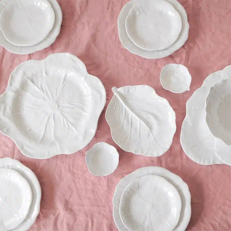 White melamine plates on a pink textured surface