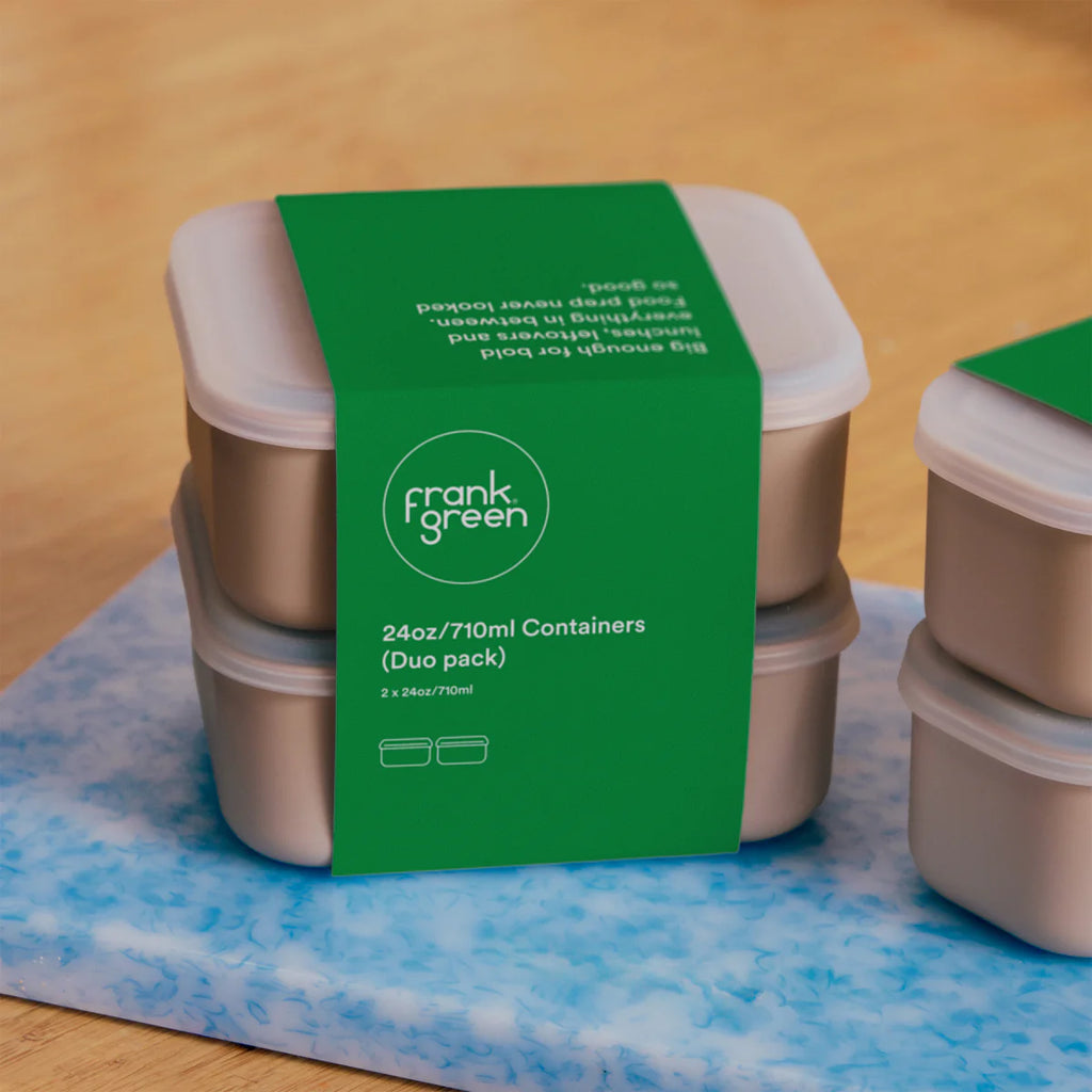 Two food storage containers with a green label on a blue and white patterned surface.