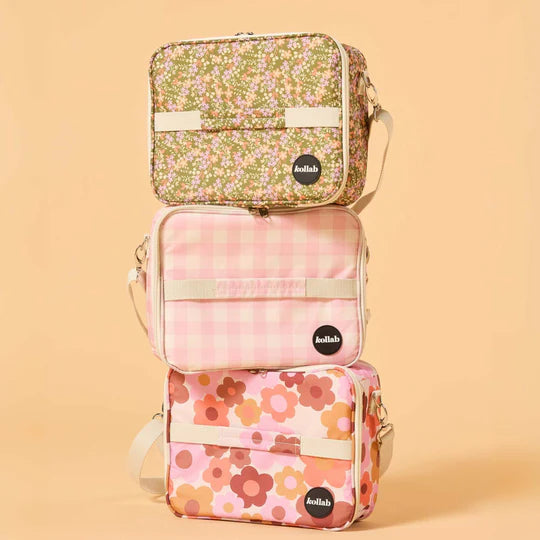 Three floral-patterned bags stacked on a beige background