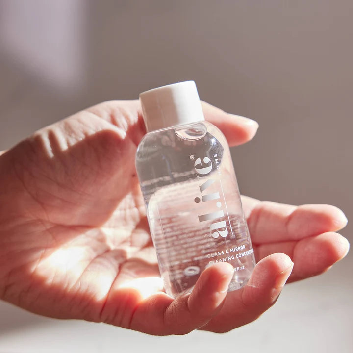 Hand holding a small bottle labeled 'slime' against a neutral background