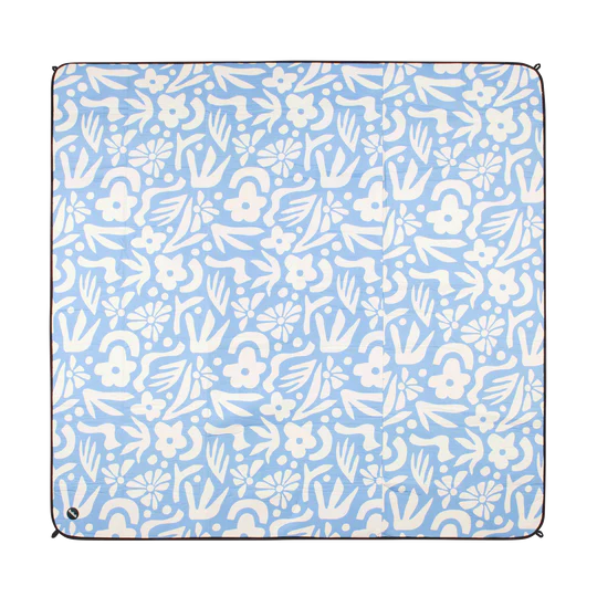 Floral patterned blanket with white flowers on a light blue background