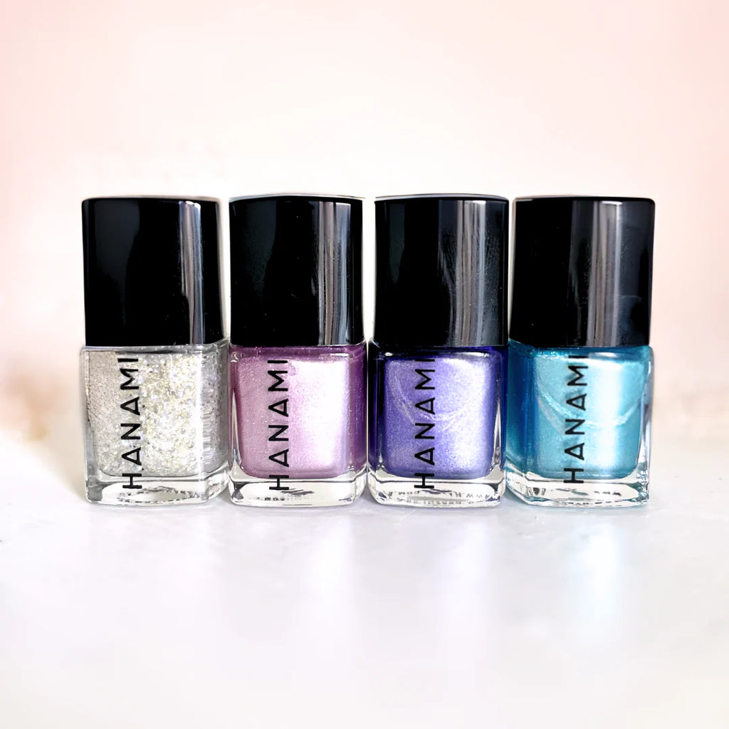 Four bottles of Hanami nail polish with different colors on a white background