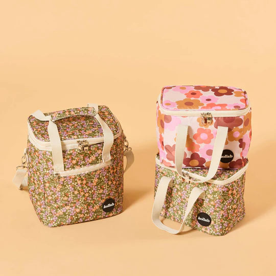 Set of three floral-patterned bags on a beige background