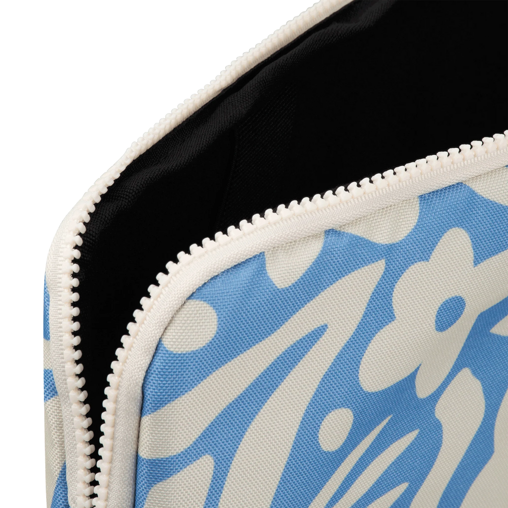 Close-up of a blue and white floral patterned pouch with a zipper.