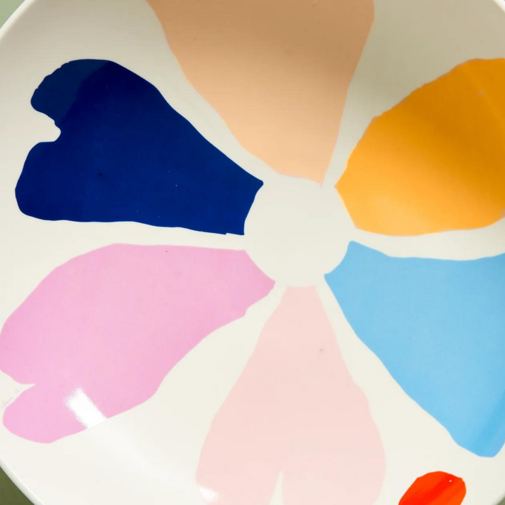 A white bowl with a painted flower design