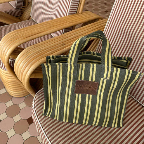 Striped bag on a chair with wicker chairs in the background