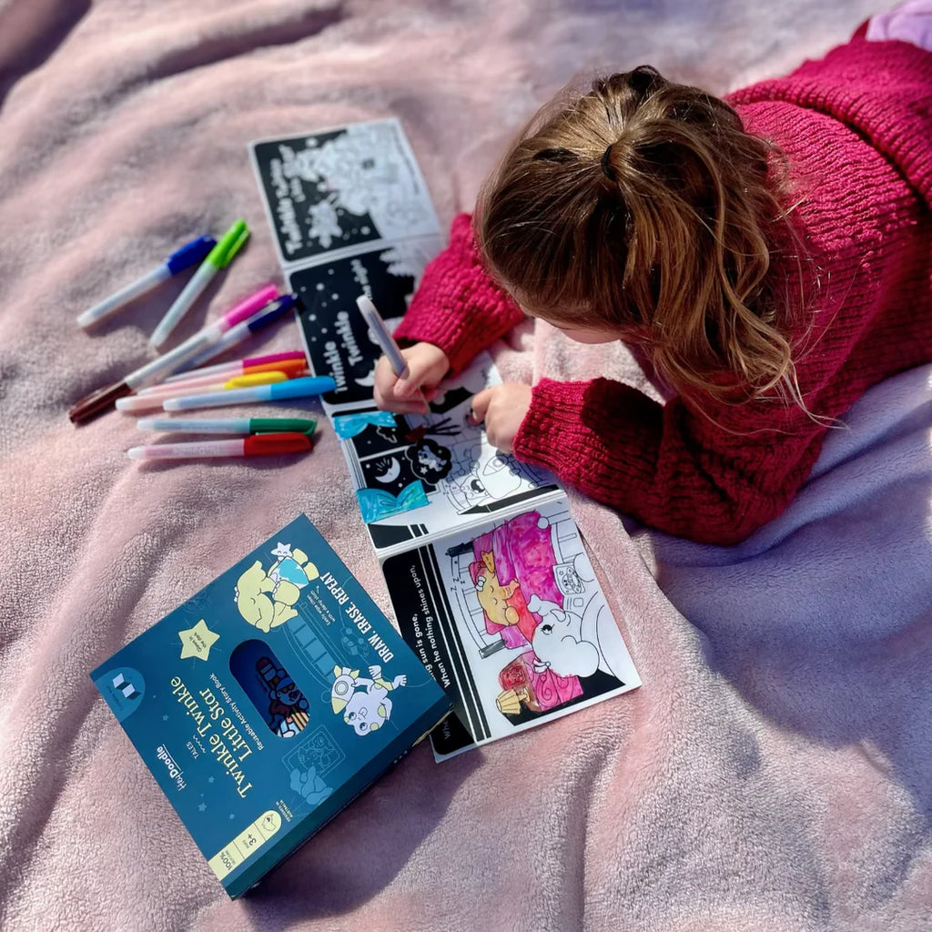 Child coloring with markers on a blanket