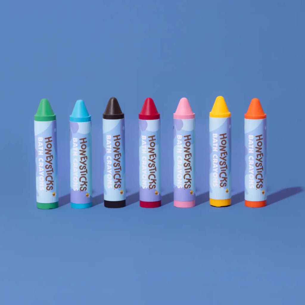 set of honey sticks bath crayons against a blue background
