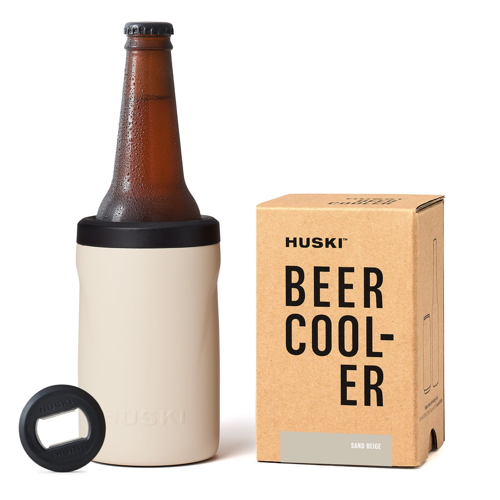 Huski beer cooler with bottle, box, and opener on a white background