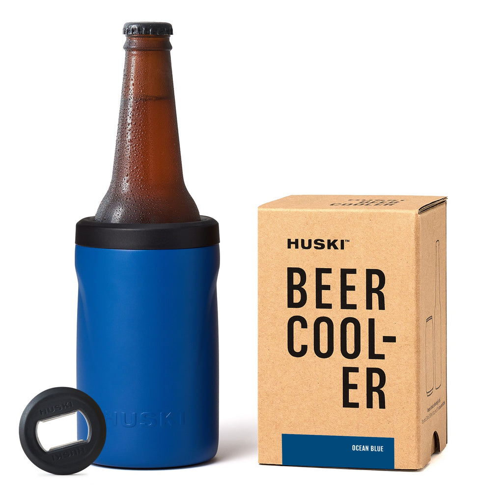 Blue beer cooler with bottle, opener, and Huski branded box on a white background