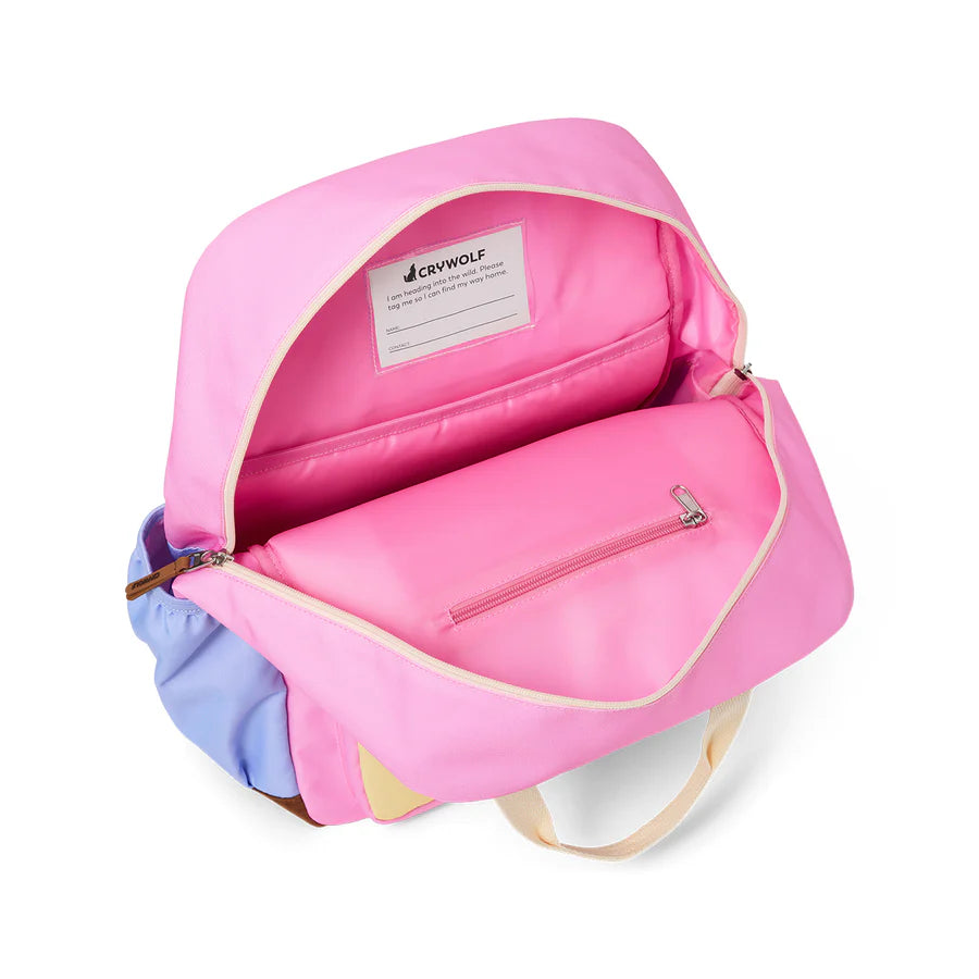 Pink backpack with a visible brand label on a white background