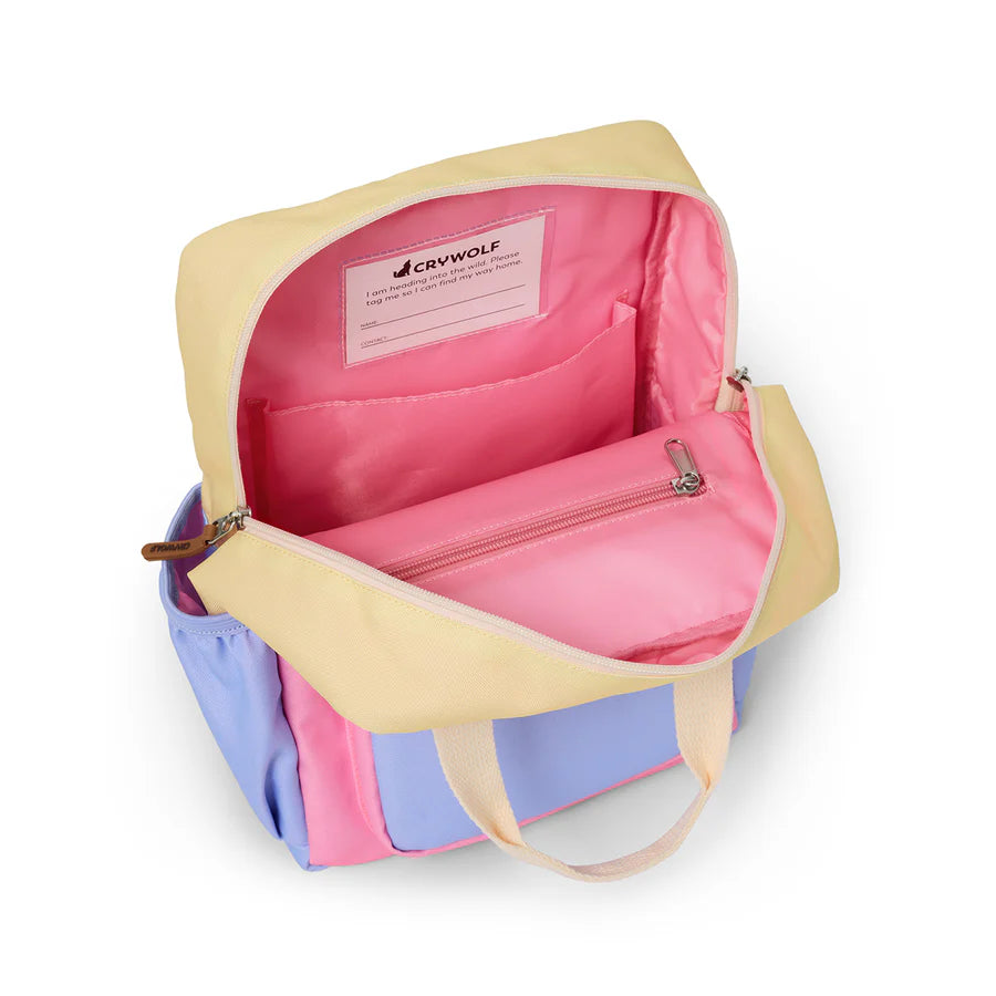 Multicolored bag with pink interior and 'Crywolf' label on a white background