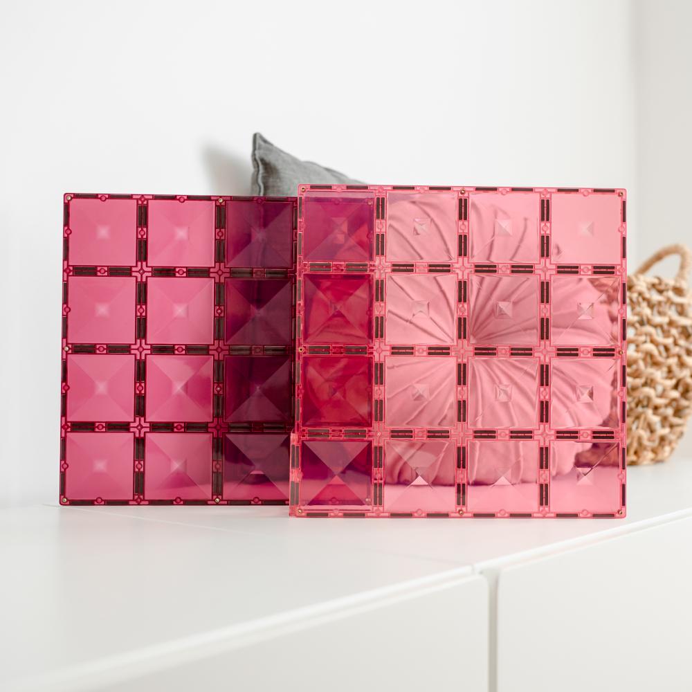 Pink transparent makeup palette with geometric designs on a white surface