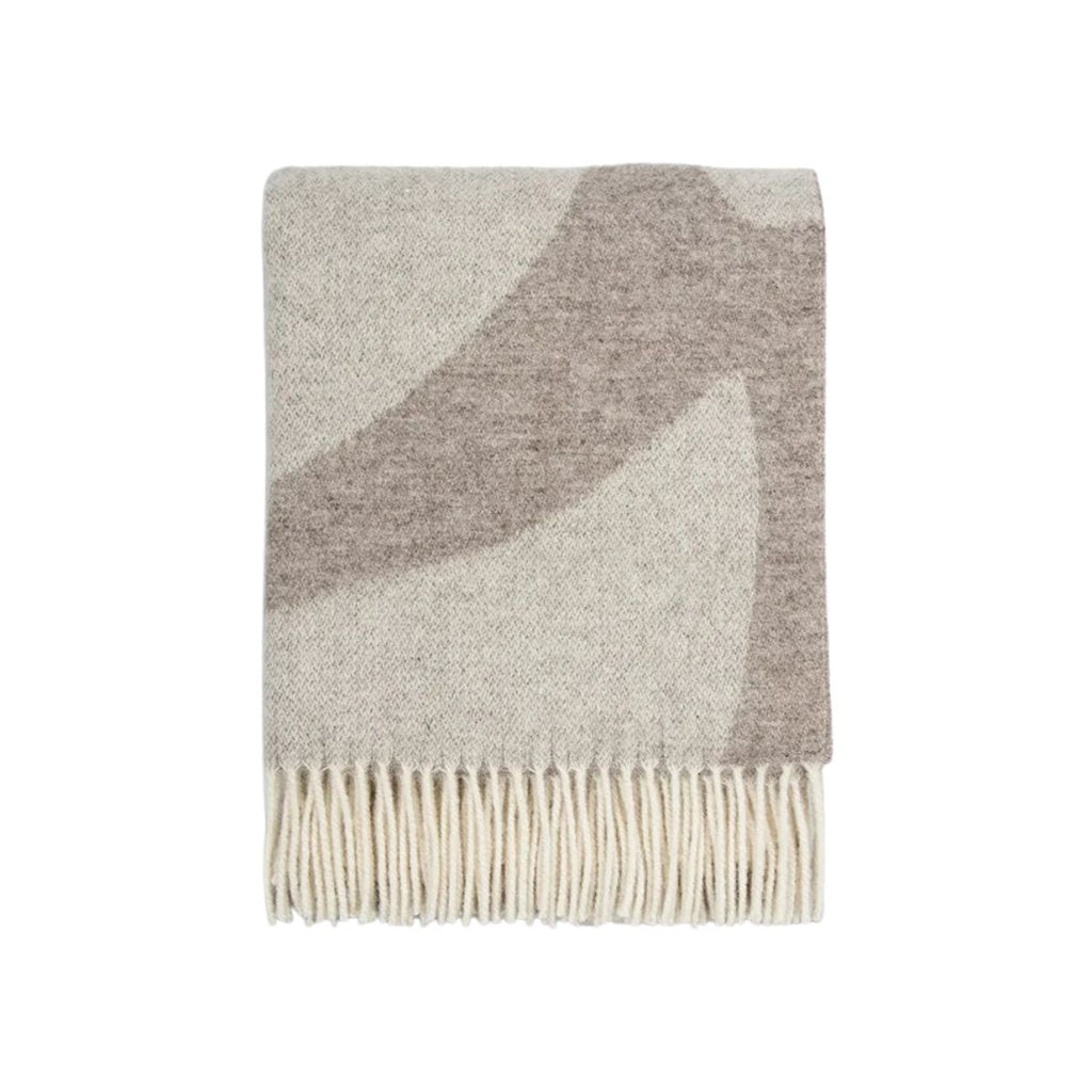 Gray and beige patterned throw blanket with white fringe on a white background