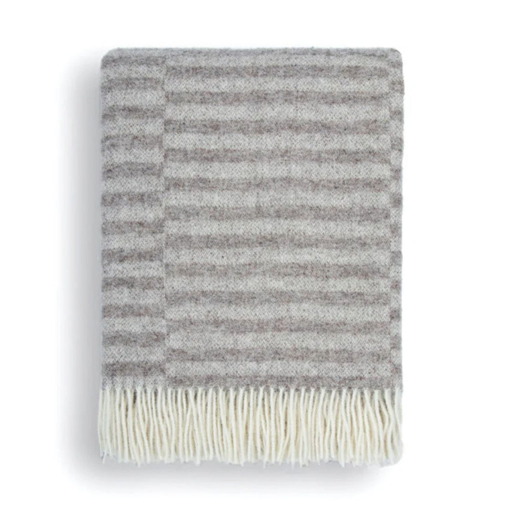 Striped blanket with white fringe on a white background