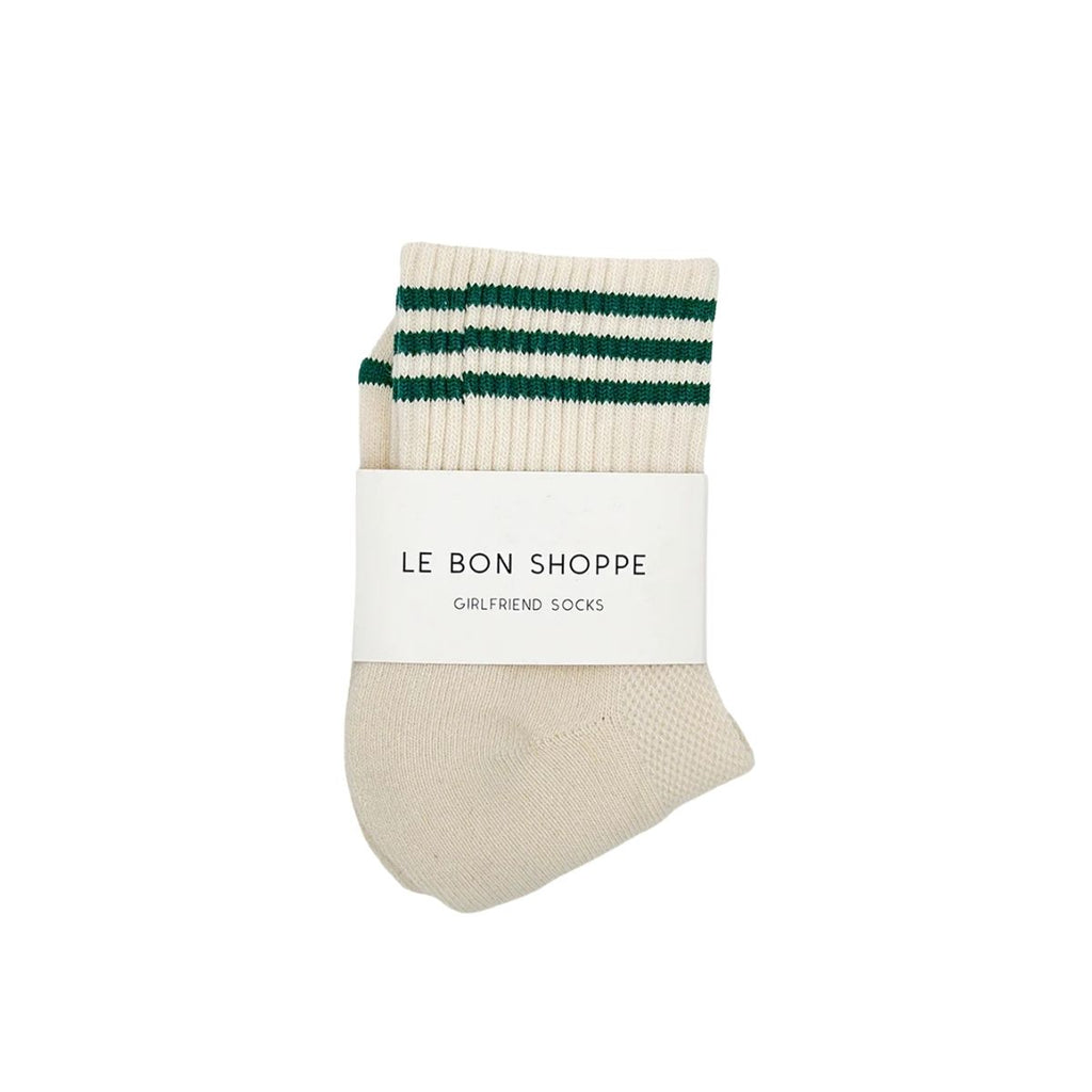 Beige sock with green stripes and 'Le Bon Shoppe' label on a white background
