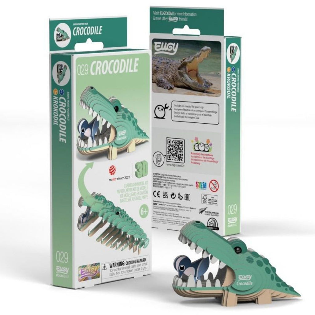 Green crocodile toy with packaging on a white background