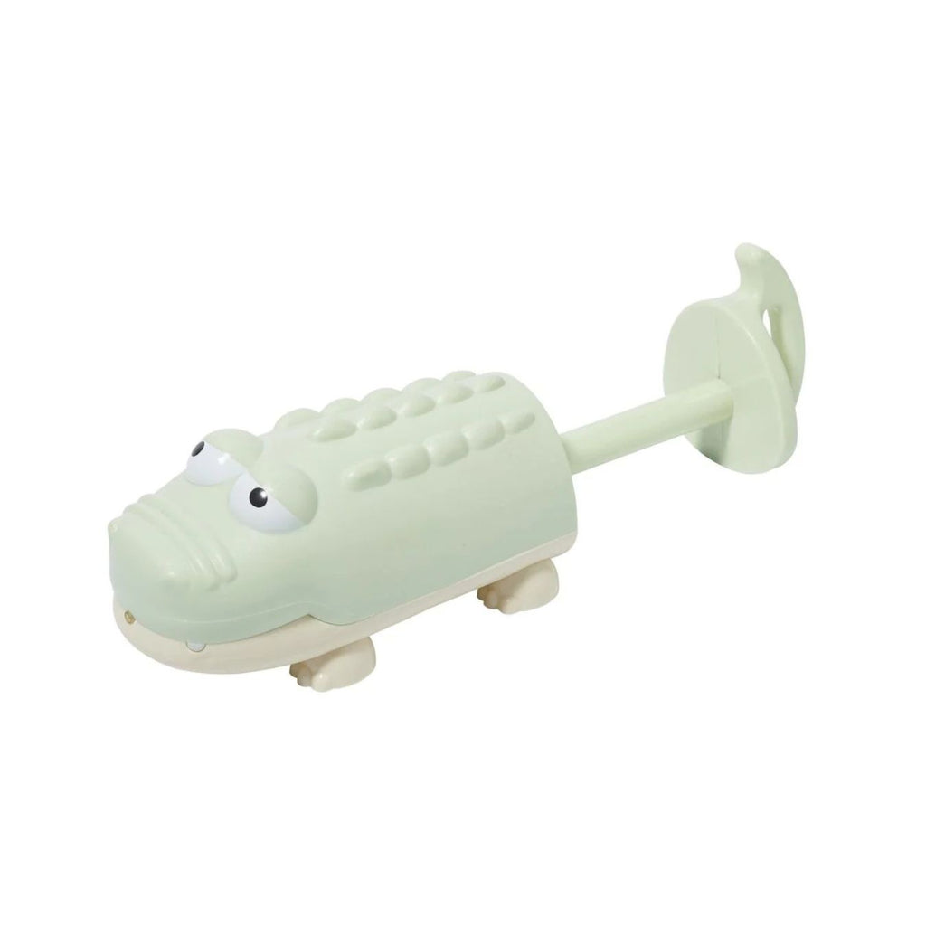 Light green alligator-shaped toy with a white background