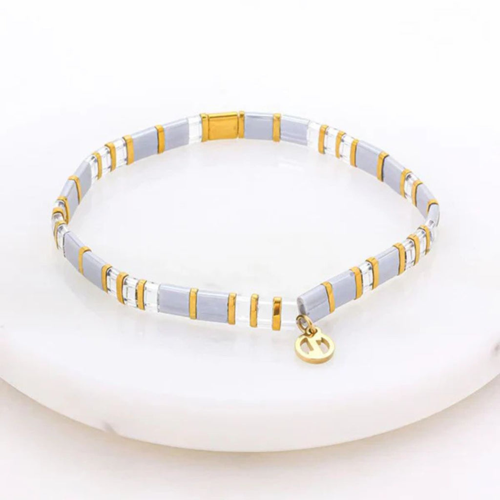 Necklace with white and gold beads on a white background