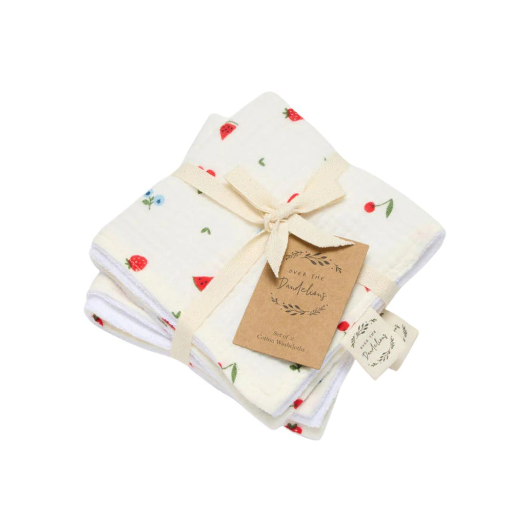 Set of folded fabric with strawberry pattern and a bow, on a white background