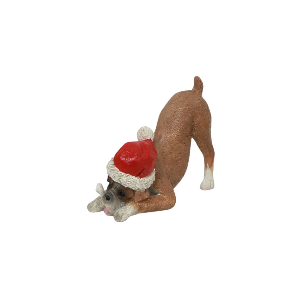 Dog figurine wearing a Santa hat on a white background
