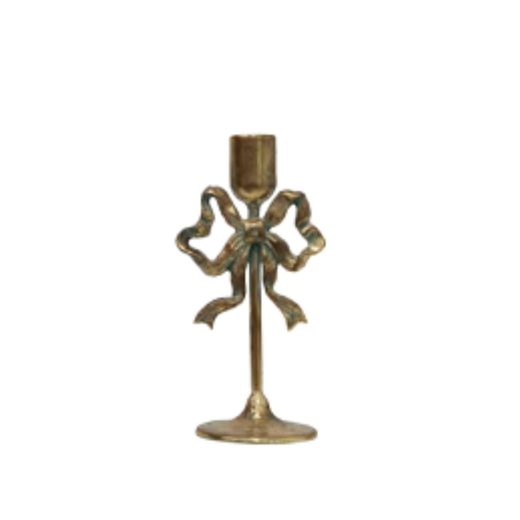 Decorative candle holder with bow design on a white background