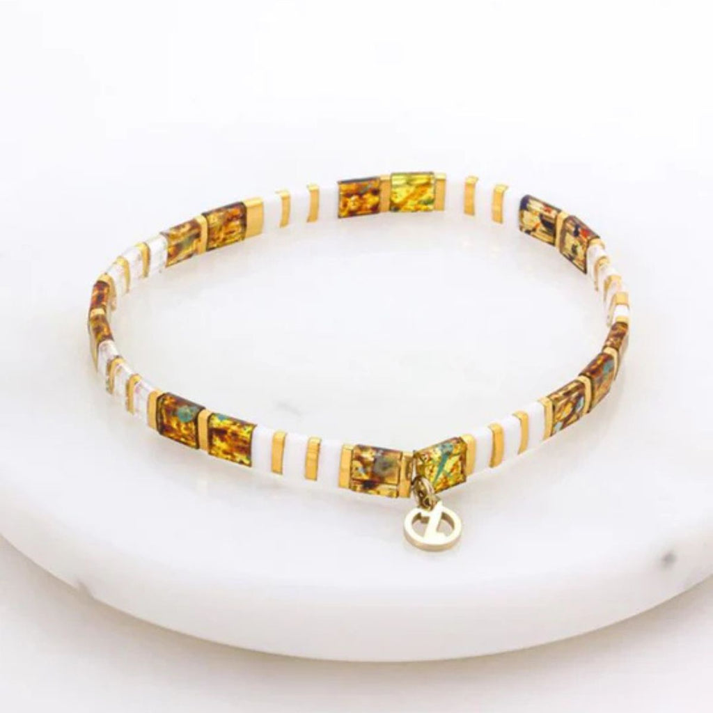 Bracelet with amber and gold accents on a white background