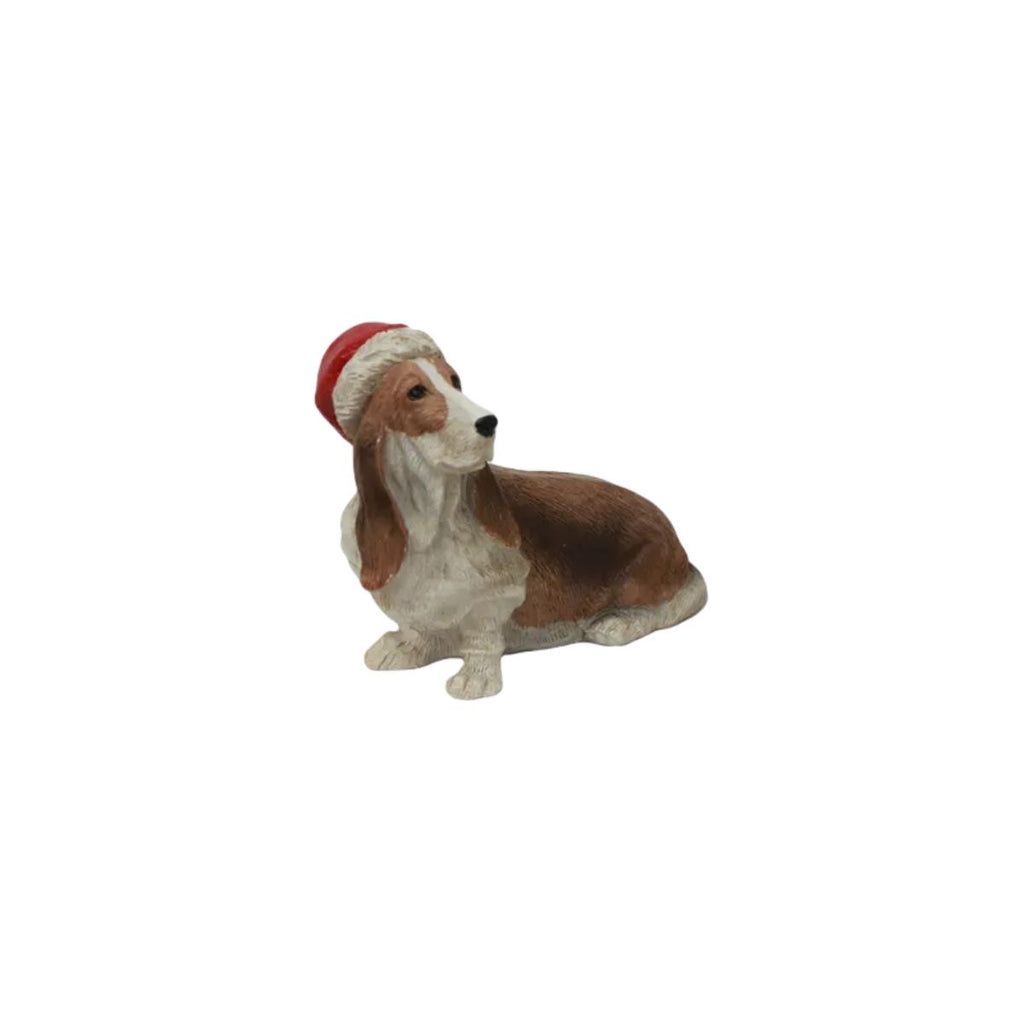 Dog figurine wearing a Santa hat on a white background