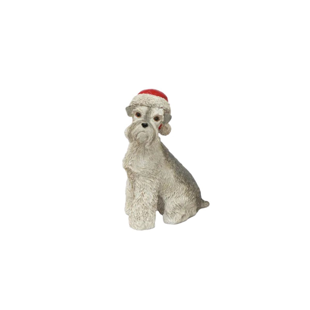 Stuffed dog toy with a red Santa hat on a white background