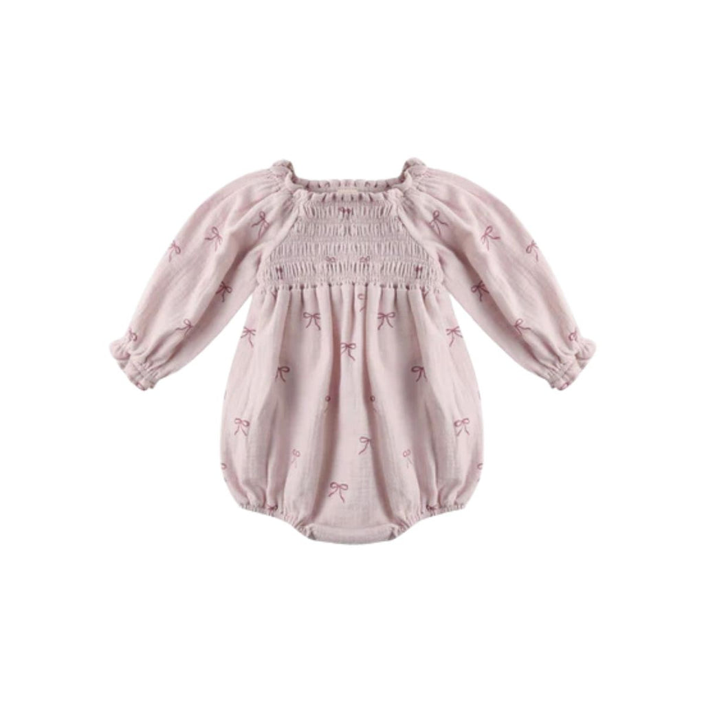 Pink baby romper with bow pattern on a white background