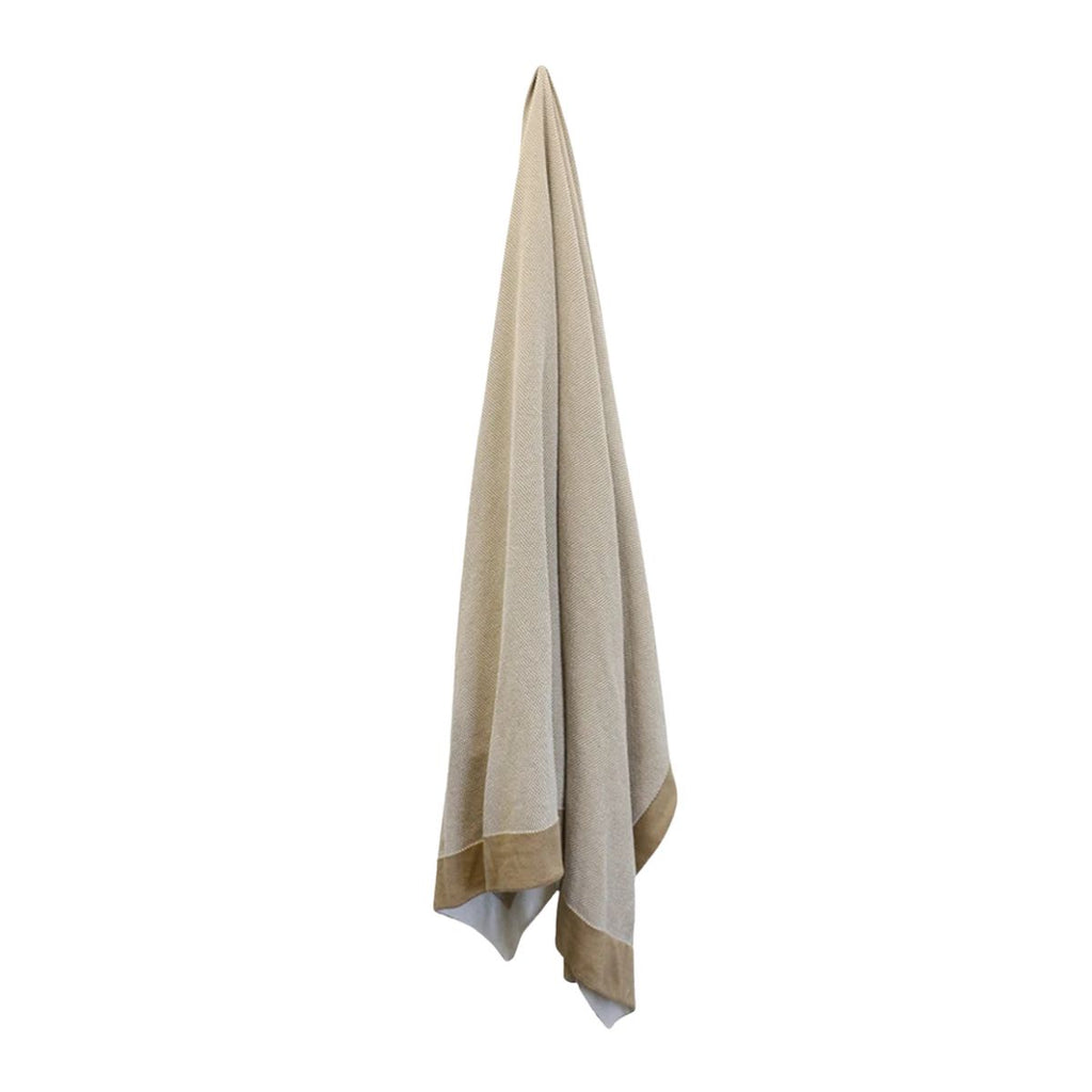 Beige towel hanging on a white background