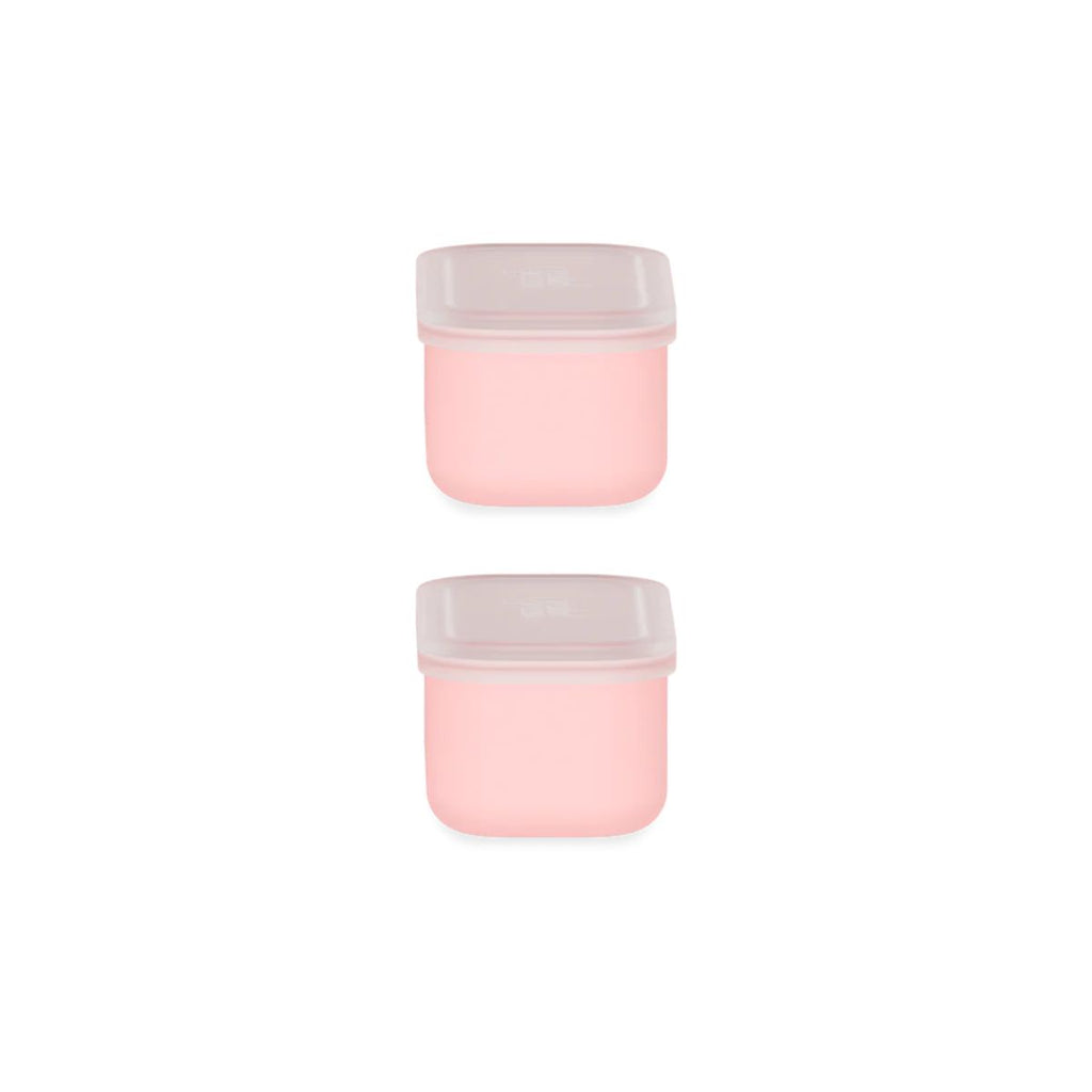 Two pink containers with white lids on a white background