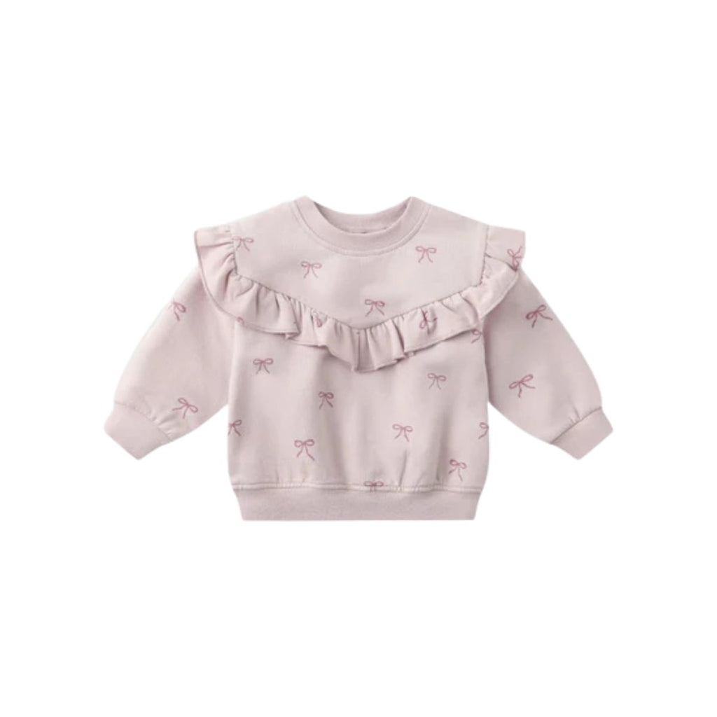 Pink sweater with ruffled details and bow patterns on a white background