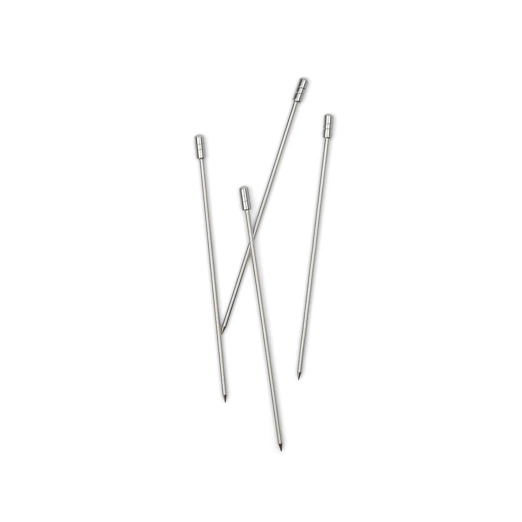 Set of metal drink picks on a white background