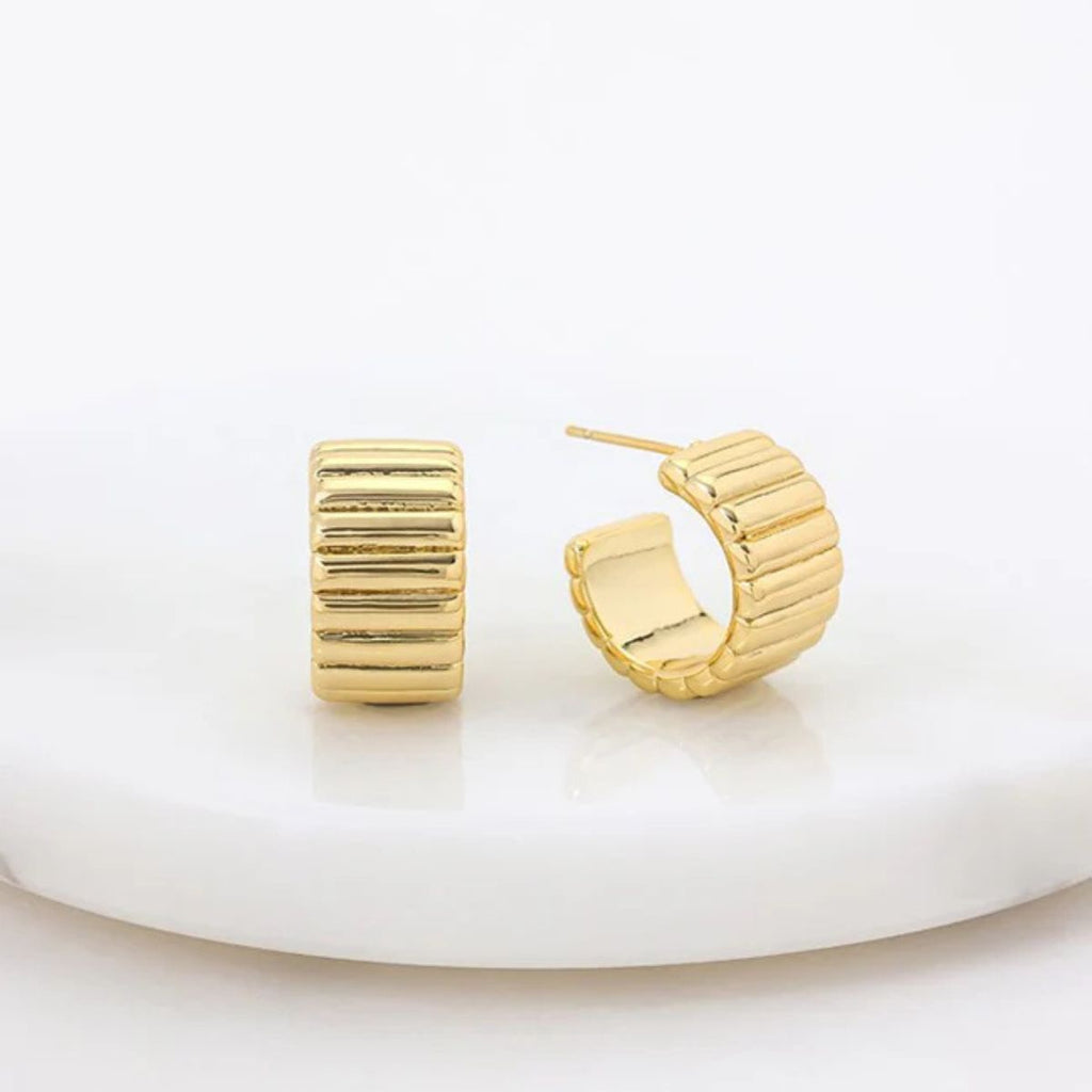 Gold hoop earrings on a white background
