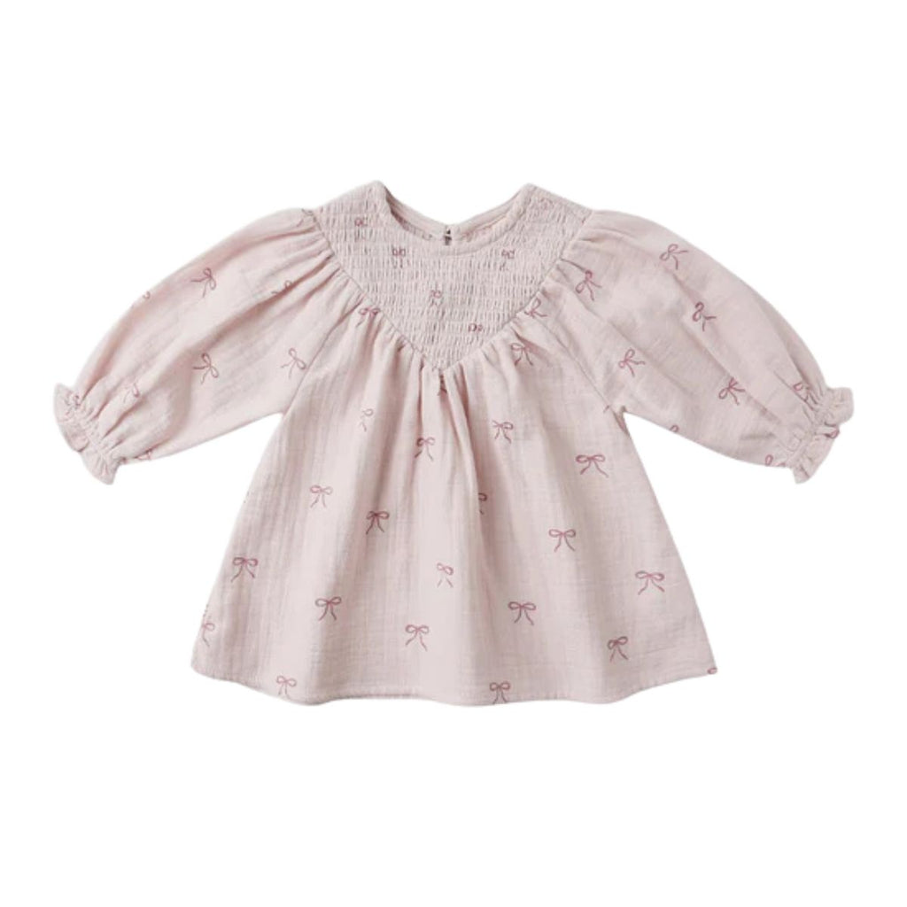 Pink baby dress with bow pattern on a white background