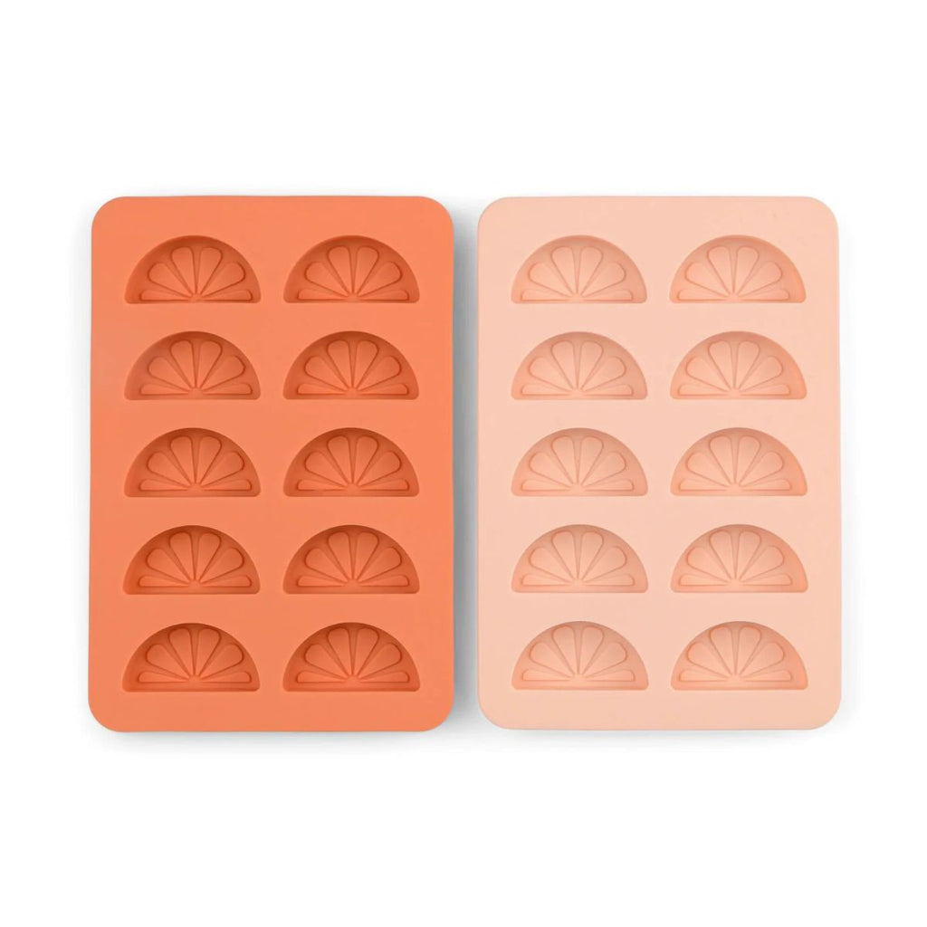 Two silicone ice cube trays with half-moon shapes on a white background
