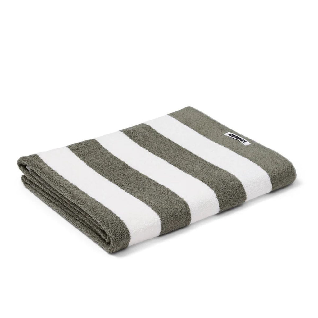 Folded green and white striped towel on a white background
