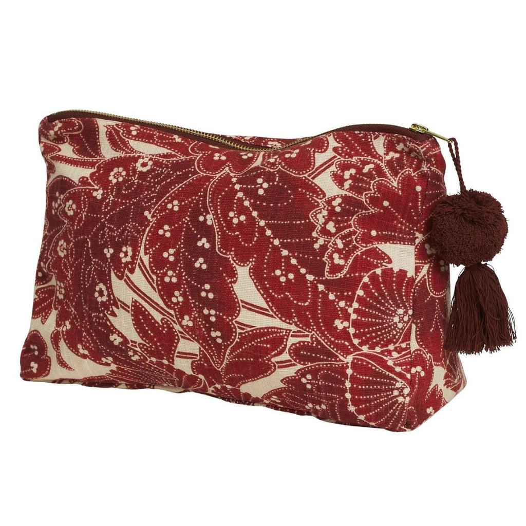 Red and white patterned pouch with a tassel on a white background