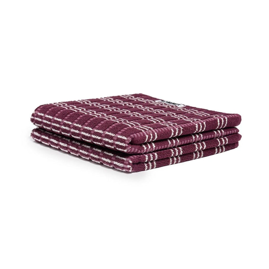 Stack purple and white checkered towels on a white background