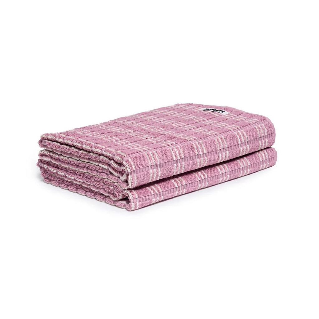 Folded pink checkered towel on a white background
