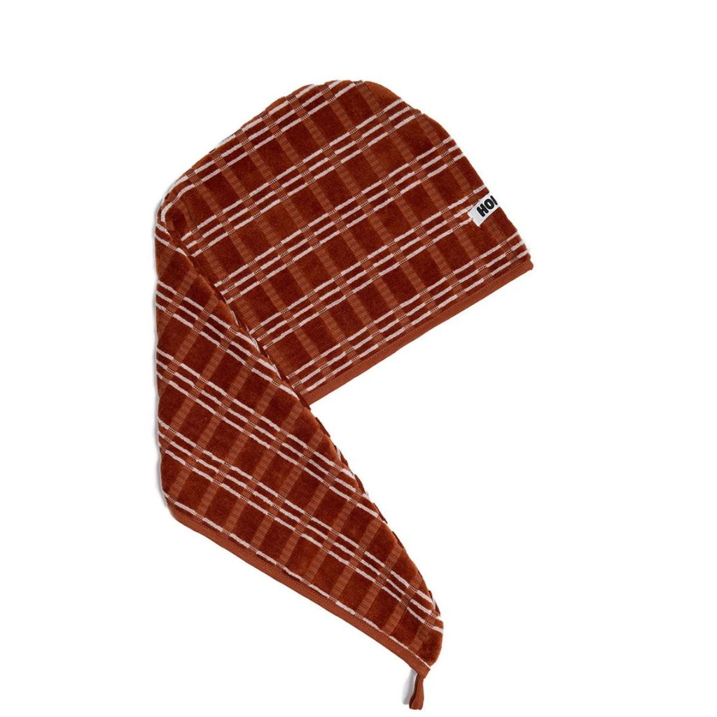 Brown plaid towel hairwrap with a brand logo on a white background