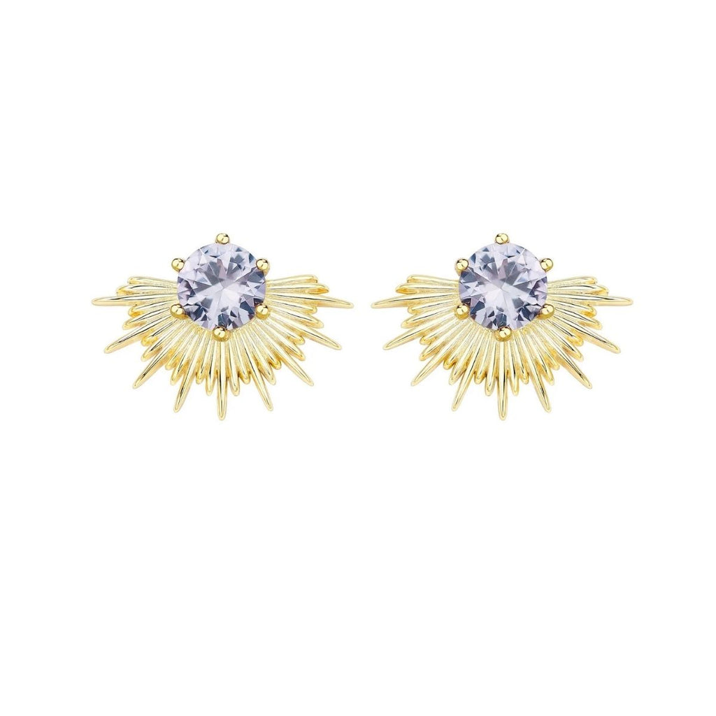 Pair of gold earrings with central gemstones on a white background