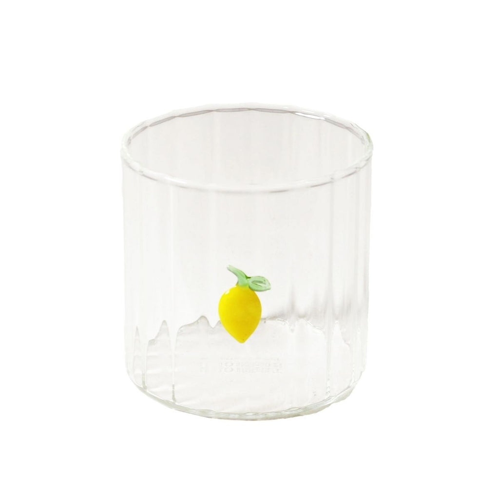 Clear glass tumbler with a lemon charm on a white background