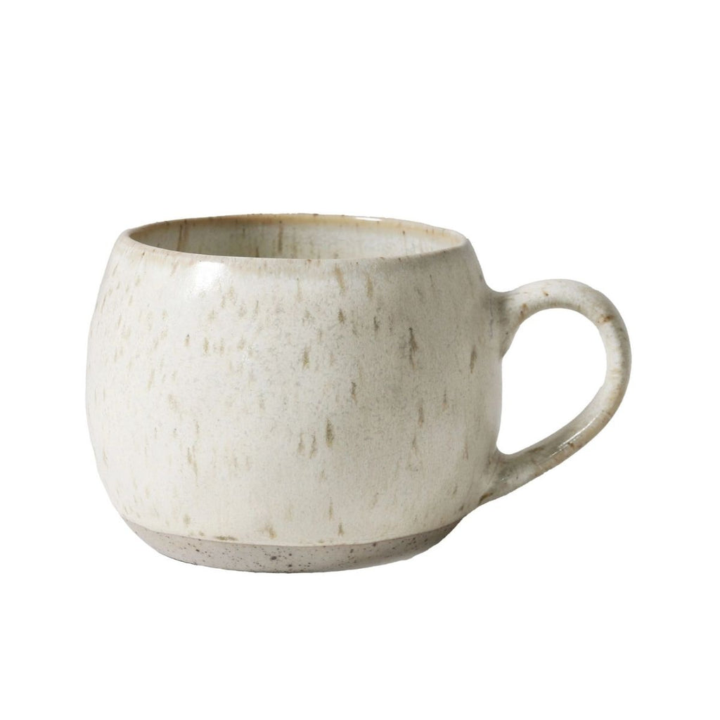 White ceramic mug with a textured surface on a white background